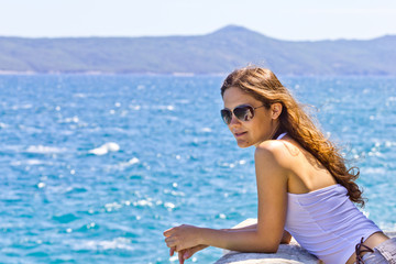 Fototapeta na wymiar Woman on the deck by the sea