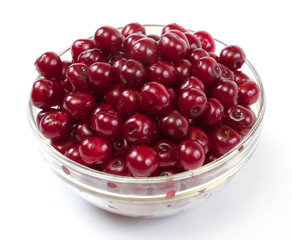 Bowl with ripe cherries. Isolated on a white background.