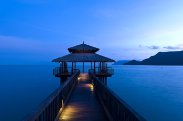 Building at the end of a jetty during twilight