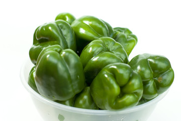 Green fresh peppers on the white background