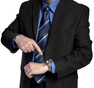 businessman is pointing at his watch