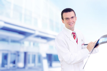 Doctor stand near the Hospital main Entrance.