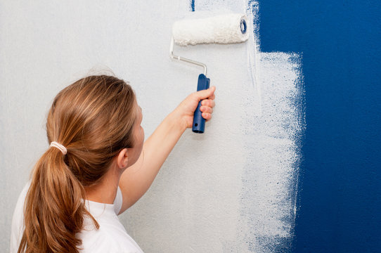 Woman Painting A Wall