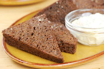 Toast from black bread with garlic sauce on a plate