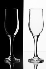 Two glasses on a black and white.