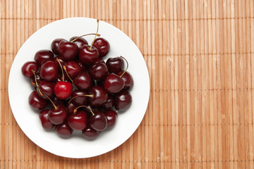 many sweet cherries on a dish