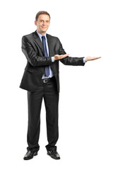 Man in suit gesturing welcome