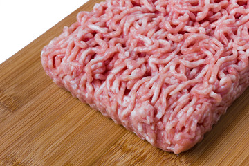 minced meat  on a wooded cutting board