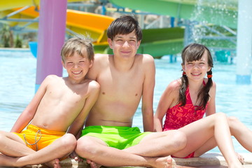 Three kids by the poolside