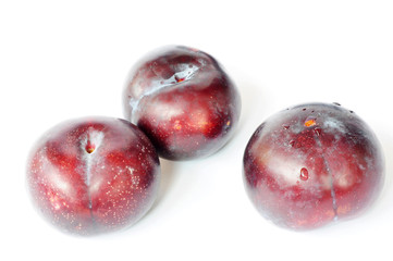 Three fresh plums