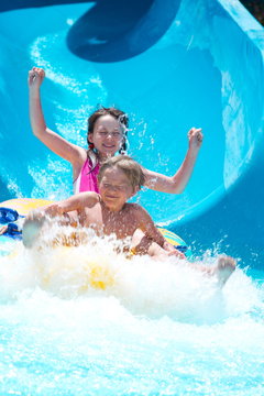 Kids Playing On Water Slide