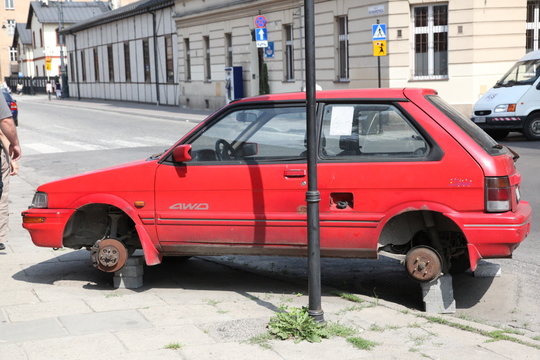 Fototapeta Red Car, parked with no wheels
