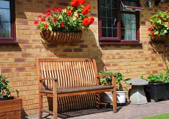 An English back Garden with Bench and Flower basket