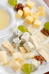 Cheese plate with grapes and honey