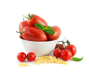 Tomatoes basil and pasta on a white background