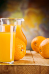 Obraz na płótnie Canvas glass with juice and oranges