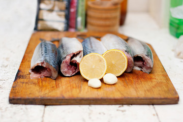 Fish carcass with spices on wooden hardboard, prepared for cooki