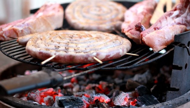 cooking grilled sausage and pork