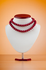Pearl necklace against gradient background