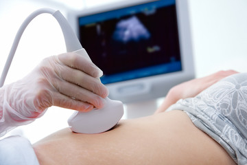 woman getting ultrasound diagnostic from doctor - obrazy, fototapety, plakaty