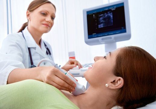 Woman Getting Ultrasound Of A Thyroid From Doctor