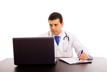 Happy young doctor working on a laptop against white background