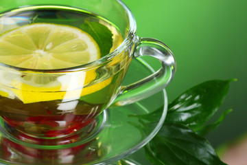 green tea in transparent cup with lime and berry