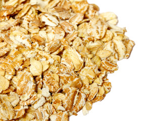 Heap of dry rolled oats isolated on white background