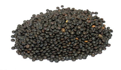 Heap of black lentil isolated on white