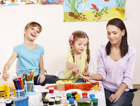 Children painting in preschool.