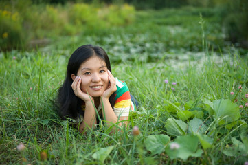 smiling woman laying on grass