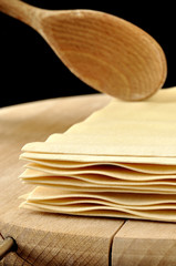 Lasagne sheets on wooden chopping board