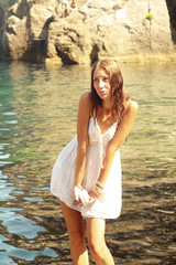 Obraz premium girl in white gown in water near mountains