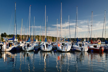 Fototapeta na wymiar Boats reflection in the lake at summer