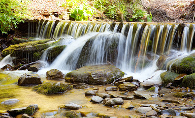 Waterfall with trees and rocks in mountain