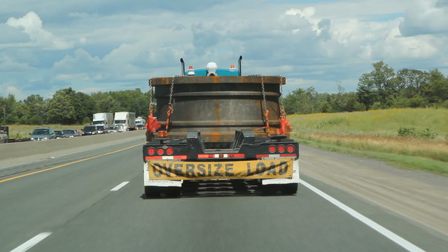 Truck with oversized load going down the highway. Ontario.