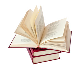 Stack of books and one book open