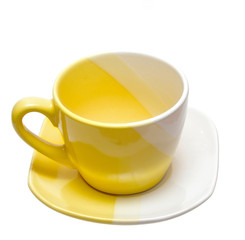 Yellow tea cup on a white background