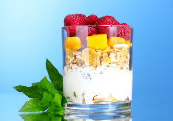 tasty cornflakes, fruit, milk in glass and mint