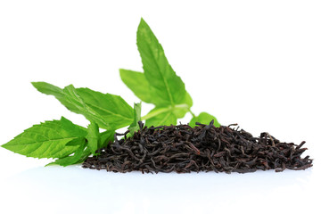 dry black tea leaves and mint isolated on white