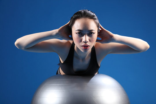 Oriental Asian Woman Back Stretch On Exercise Ball