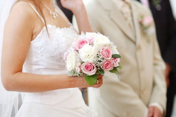 Obraz na płótnie Canvas Bride holding bride bouquet during wedding ceremony