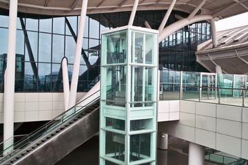 Glass elevator and escalator - obrazy, fototapety, plakaty