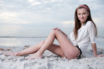 Happy girl enjoys sunny day at the beach.