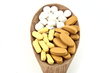 Fototapeta na wymiar The pills on ladle made from wood.