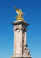 Fototapeta na wymiar Golden statue decorating Alexandre bridge, Paris, France