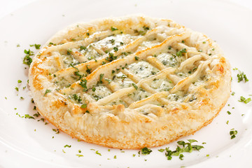 tasty quiche with cheese and herbs