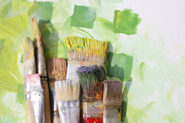 breite borstenpinsel auf gemaltem hintergrund