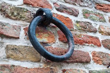 Rusty old ring at a city wall