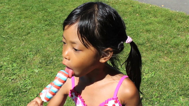 Little Girl Enjoying A Popsicle